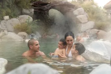 a group of people in a pool of water